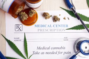 Patient holding a new medical marijuana card.